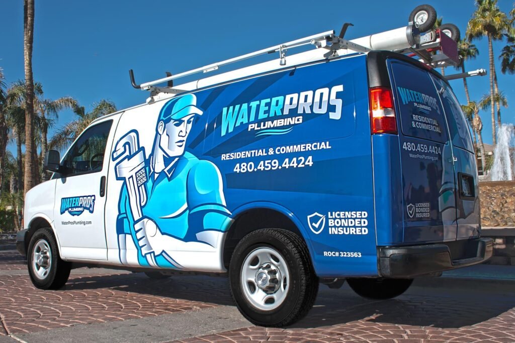 Branded plumbing van showing mobile advertising in a local area